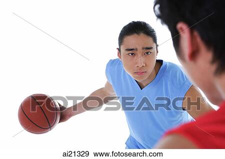 Two men playing basketball, over the shoulder view View Large Photo Image Stock Photo - Two men playing basketball, over the shoulder view. Fotosearch