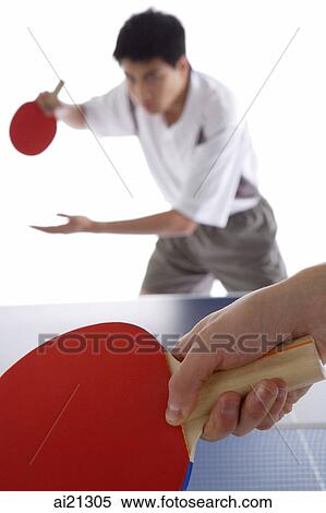 Two men playing table tennis, focus on the foreground View Large Photo Image Stock Photography - Two men playing table tennis, focus on the foreground. Fotosearch