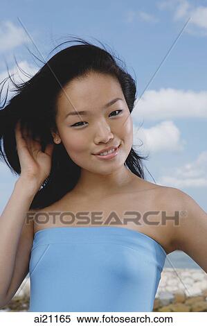 Woman in blue tube top, smiling at camera View Large Photo Image Stock Photography - Woman in blue tube top, smiling at camera. Fotosearch