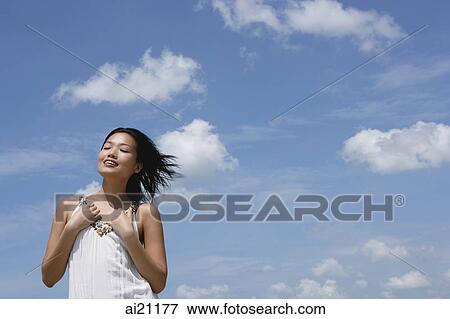 Woman in white top, smiling, eyes closed View Large Photo Image Stock Photo - Woman in white top, smiling, eyes closed. Fotosearch