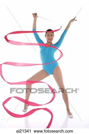 Stock Image - Woman performing rhythmic gymnastics with ribbon. Fotosearch