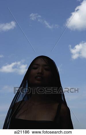 Woman with black scarf over her head View Large Photo Image Stock Photograph - Woman with black scarf over her head. Fotosearch