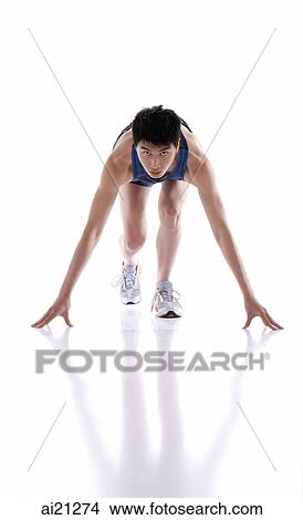 Young man bending over in runner's starting position View Large Photo Image Picture - Young man bending over in runner's starting position. Fotosearch