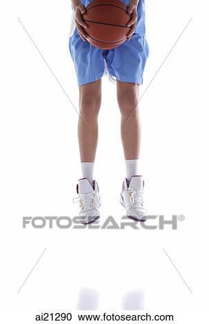 Young man jumping, holding basketball, low section, cropped image View Large Photo Image Stock Image - Young man jumping, holding basketball, low section, cropped image. Fotosearch