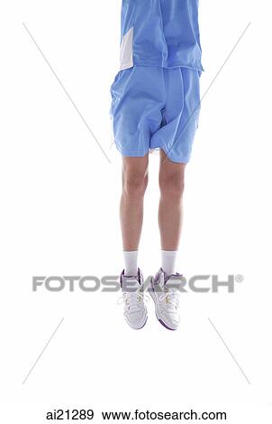 Young man jumping in air, low section, cropped image View Large Photo Image Stock Photo - Young man jumping in air, low section, cropped image. Fotosearch