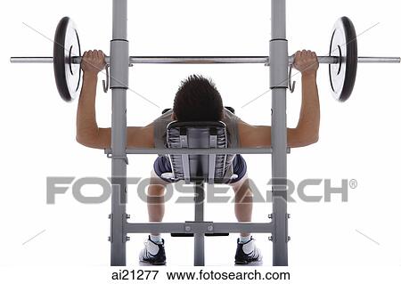 Stock Photo - Young man lifting weights. Fotosearch