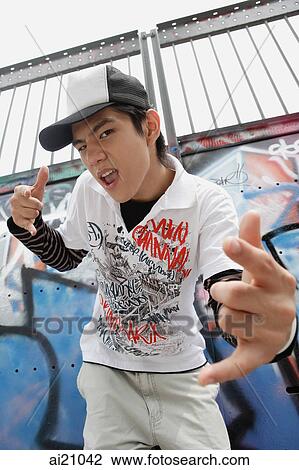 Young man making hand sign at camera View Large Photo Image Stock Image - Young man making hand sign at camera. Fotosearch