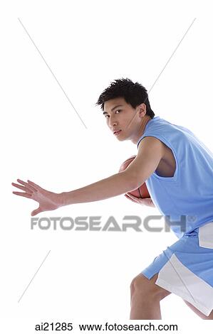 Young man playing basketball, arm outstretched View Large Photo Image Stock Photography - Young man playing basketball, arm outstretched. Fotosearch