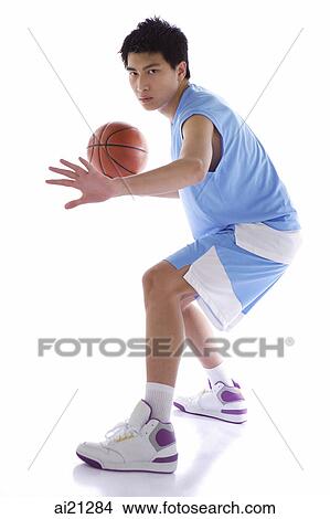 Young man playing basketball View Large Photo Image Picture - Young man playing basketball. Fotosearch