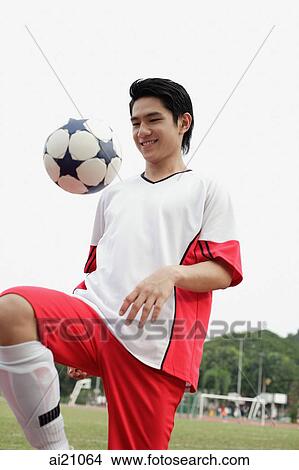Young man playing with soccer ball View Large Photo Image Picture - Young man playing with soccer ball. Fotosearch