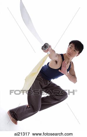 Young man practicing Kong fu with sword View Large Photo Image Stock Photo - Young man practicing Kong fu with sword. Fotosearch