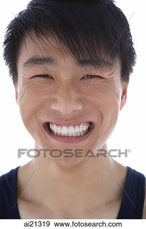 Young man smiling at camera, head shot View Large Photo Image Stock Photo - Young man smiling at camera, head shot. Fotosearch