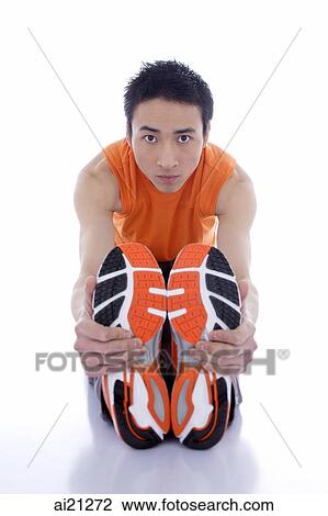 Young man stretching, looking at camera View Large Photo Image Stock Image - Young man stretching, looking at camera. Fotosearch