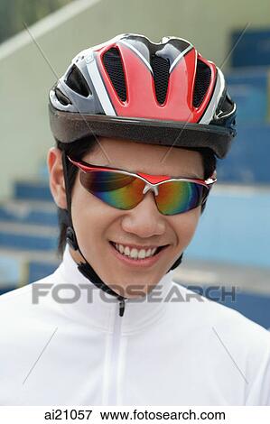 Young man wearing cycling helmet and sunglasses View Large Photo Image Stock Photo - Young man wearing cycling helmet and sunglasses. Fotosearch