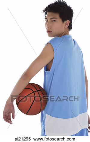Young man with basketball, looking over shoulder View Large Photo Image Stock Photography - Young man with basketball, looking over shoulder. Fotosearch