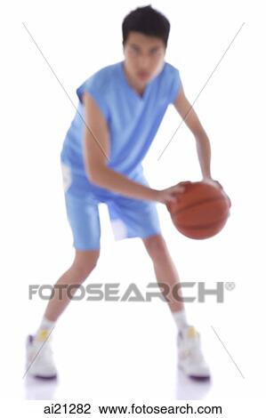 Stock Image - Young man with basketball. Fotosearch