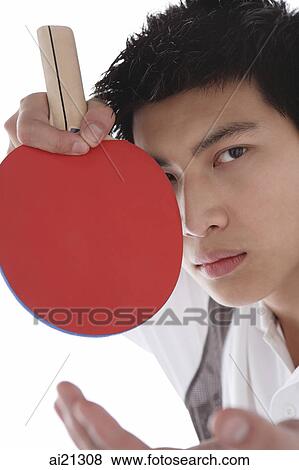 Young man with table tennis paddle, looking at camera View Large Photo Image Stock Photo - Young man with table tennis paddle, looking at camera. Fotosearch