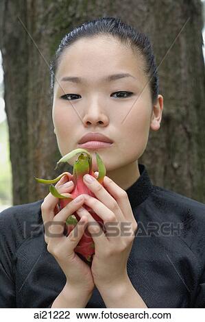 Young woman holding dragon fruit View Large Photo Image Stock Image - Young woman holding dragon fruit. Fotosearch