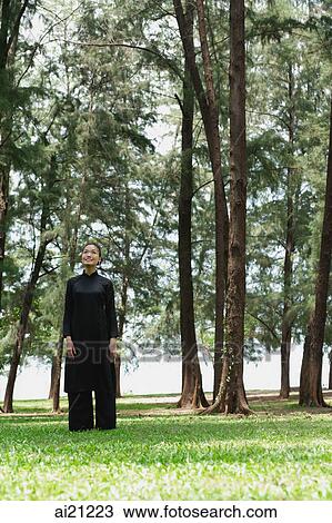 Young woman in traditional Chinese costume, standing amongst trees View Large Photo Image Stock Image - Young woman in traditional Chinese costume, standing amongst trees. Fotosearch