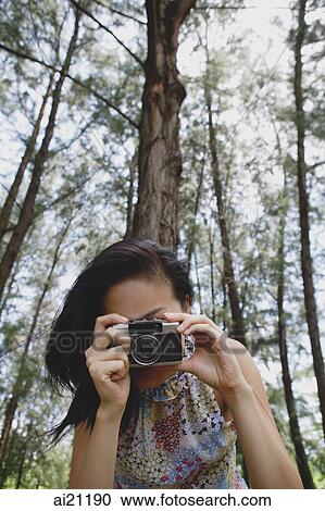 Young woman with camera, taking a picture View Large Photo Image Stock Image - Young woman with camera, taking a picture. Fotosearch