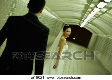 Bride and groom walking in tunnel, bride walking ahead of groom View Large Photo Image Stock Image - Bride and groom walking in tunnel, bride walking ahead of groom. Fotosearch