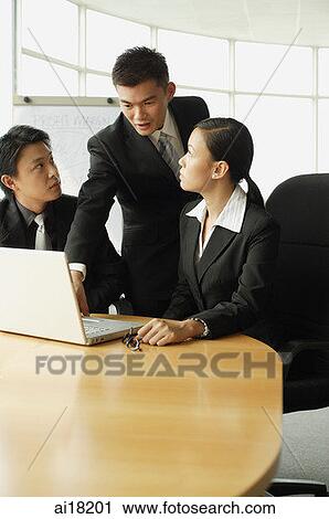 Business people in office, working together around laptop View Large Photo Image Stock Image - Business people in office, working together around laptop. Fotosearch