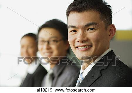 Business people seating in a row, focus on the businessman in foreground View Large Photo Image Stock Photo - Business people seating in a row, focus on the businessman in foreground. Fotosearch