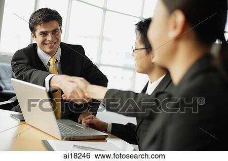 Business people shaking hands across table View Large Photo Image Stock Photograph - Business people shaking hands across table. Fotosearch
