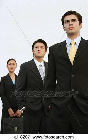 Business people standing in a row, looking away View Large Photo Image Stock Photo - Business people standing in a row, looking away. Fotosearch