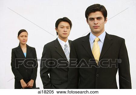 Stock Photography - Business people standing, looking at camera, in a row. Fotosearch