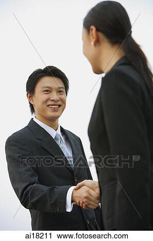 Businessman and businesswoman shaking hands View Large Photo Image Stock Image - Businessman and businesswoman shaking hands. Fotosearch
