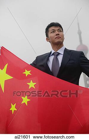 Businessman holding China flag, Oriental Pearl TV Tower in the background View Large Photo Image Stock Image - Businessman holding China flag, Oriental Pearl TV Tower in the background. Fotosearch