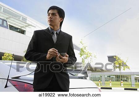 Stock Image - Businessman holding PDA. Fotosearch