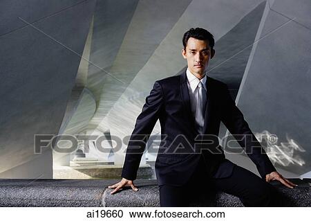 Stock Image - Businessman in tunnel, looking at camera. Fotosearch