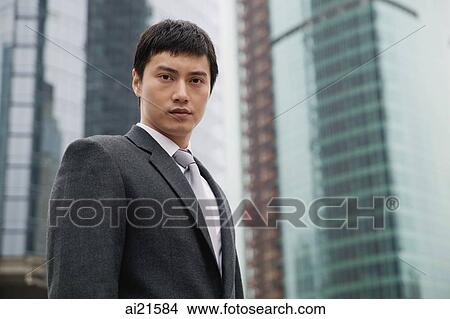 Businessman looking at camera, city location View Large Photo Image Picture - Businessman looking at camera, city location. Fotosearch