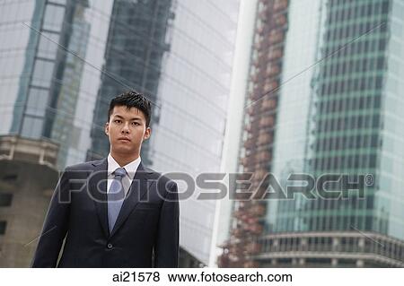 Businessman looking at camera, city location View Large Photo Image Stock Photo - Businessman looking at camera, city location. Fotosearch
