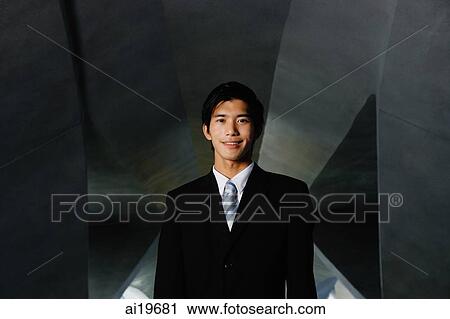 Businessman looking at camera, smiling View Large Photo Image Stock Image - Businessman looking at camera, smiling. Fotosearch