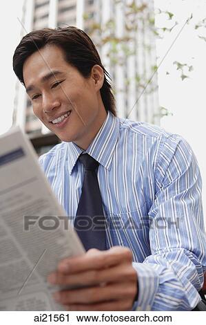 Businessman sitting in the city, reading newspaper View Large Photo Image Stock Image - Businessman sitting in the city, reading newspaper. Fotosearch