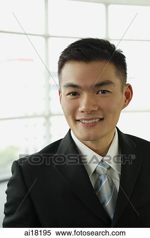 Businessman smiling at camera, portrait View Large Photo Image Stock Photography - Businessman smiling at camera, portrait. Fotosearch