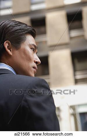 Businessman standing in the city, profile View Large Photo Image Stock Photograph - Businessman standing in the city, profile. Fotosearch