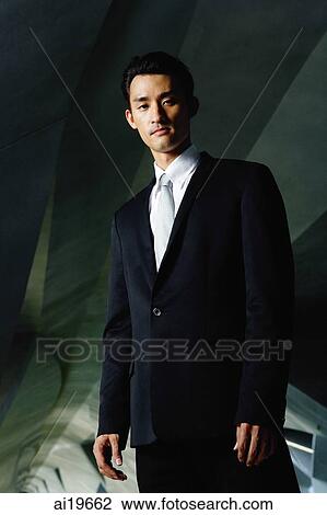 Businessman standing in tunnel, looking at camera View Large Photo Image Stock Image - Businessman standing in tunnel, looking at camera. Fotosearch
