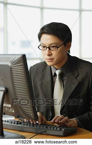 Businessman using computer View Large Photo Image Stock Photo - Businessman using computer. Fotosearch