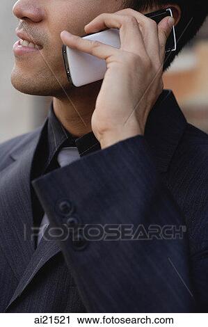 Businessman using mobile phone, cropped image View Large Photo Image Stock Image - Businessman using mobile phone, cropped image. Fotosearch