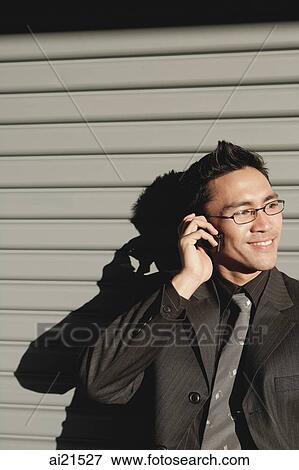 Businessman using mobile phone, smiling View Large Photo Image Stock Photo - Businessman using mobile phone, smiling. Fotosearch
