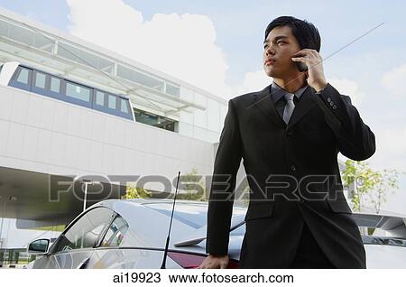 Stock Image - Businessman using mobile phone. Fotosearch