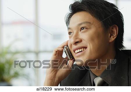 Stock Photo - Businessman using mobile phone. Fotosearch