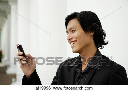 Businessman using mobile phone, text messaging View Large Photo Image Stock Photograph - Businessman using mobile phone, text messaging. Fotosearch