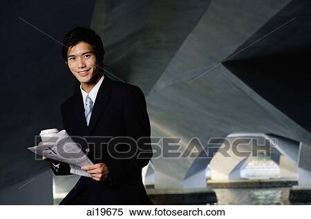 Businessman with coffee cup and newspaper, looking at camera View Large Photo Image Stock Photography - Businessman with coffee cup and newspaper, looking at camera. Fotosearch