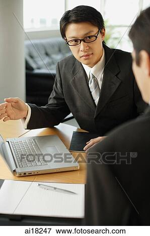 Businessmen having a discussion View Large Photo Image Stock Photo - Businessmen having a discussion. Fotosearch
