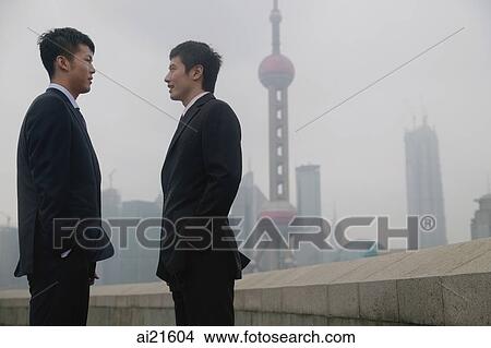 Businessmen talking, Oriental Pearl TV Tower in the background View Large Photo Image Picture - Businessmen talking, Oriental Pearl TV Tower in the background. Fotosearch